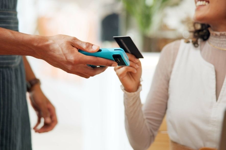 person paying with credit card by tapping