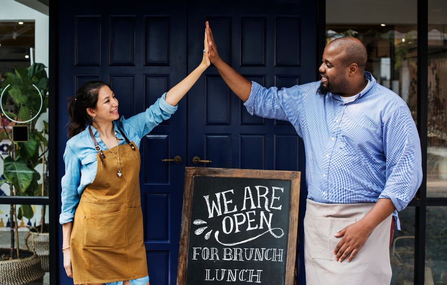 happy business owners giving high five